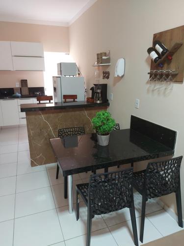 a kitchen with a table with a potted plant on it at Dunas Residence - Casa 06 in Santo Amaro