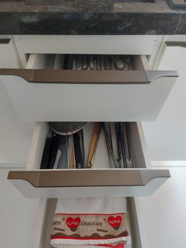 a drawer in a cabinet filled with cooking utensils at Dunas Residence - Casa 06 in Santo Amaro