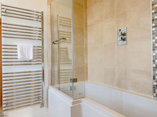 a shower with a glass door in a bathroom at 2 Bed in Langtoft 82339 in Weaverthorpe