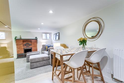a dining room with a table and chairs and a living room at 2 Mi to Downtown Denver Stylish Gem with Fireplace! in Denver