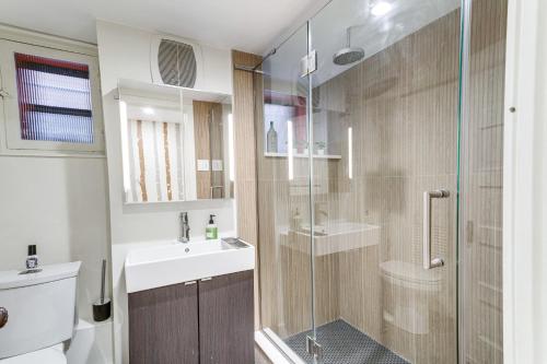 a bathroom with a shower and a sink and a toilet at 2 Mi to Downtown Denver Stylish Gem with Fireplace! in Denver