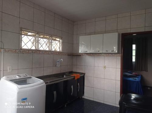 a kitchen with a counter and a sink and a window at Apartamento Aconchegante in Rondonópolis