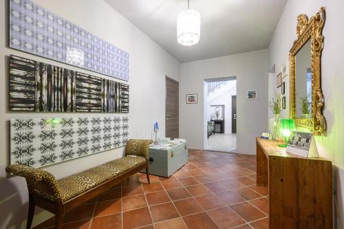 a living room with a bench and a mirror at Villa Rocco Country House in Ozzano Monferrato