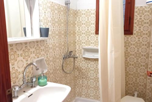 a bathroom with a sink and a shower at Apartments Papadioti in Pefki