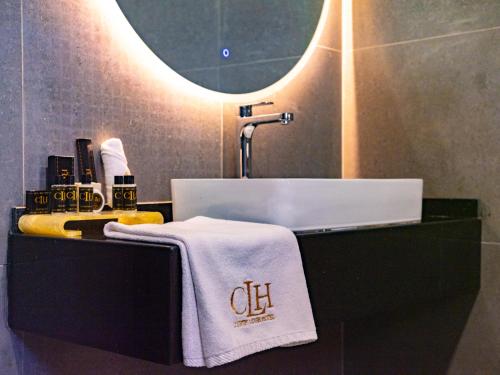 a bathroom with a sink and a towel on a counter at The Country Lodge Hotel in Freetown