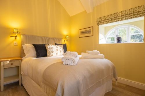 a bedroom with a bed with towels on it at The Coach House R 6 in Ringstead