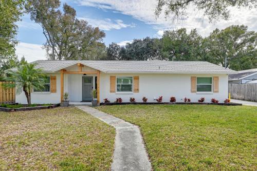 a small white house with a yard at Idyllic Tampa Home with Private Pool 11 Mi to Beach in Lutz