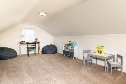 an attic room with two bean bags and a table and chairs at Salisbury Hideaway in Salisbury