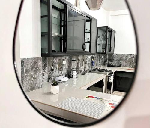 un reflet d'une cuisine avec un clavier dans un miroir dans l'établissement Apartamento acogedor y céntrico en Tena, à Tena