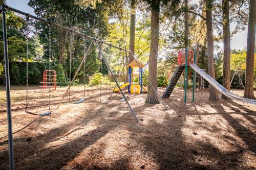 a playground with a swing set in a park at Salisbury Hideaway in Salisbury