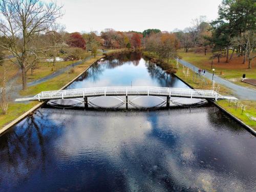 a bridge over a river in a park at Salisbury Hideaway in Salisbury