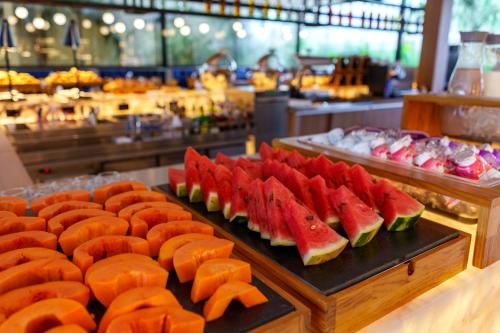 a buffet with watermelon and other fruits on display at Pousada Apple House Paraty in Paraty