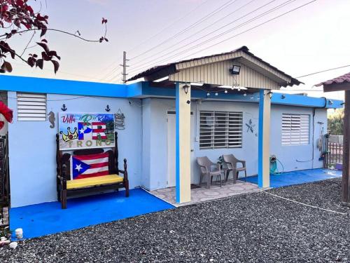 a blue and white house with a bed in front at Villa Retiro R in Boquerón Area in Cabo Rojo