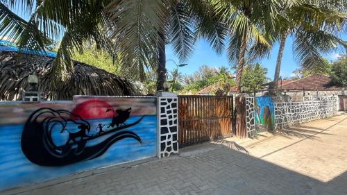 a painting on the side of a fence at Hakuna Matata Arugambay in Arugam Bay