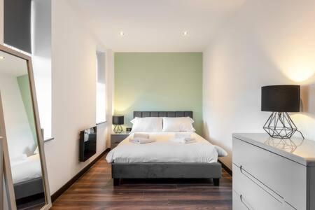 a bedroom with a bed and a large mirror at Smart 2 Bed Apartment with Parking in Central Hull in Hull