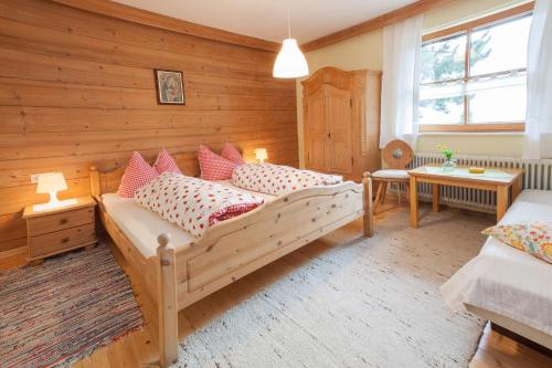 a bedroom with a large bed with pillows on it at Apart Monika in Wenns