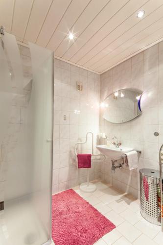 a white bathroom with a sink and a mirror at Apart Monika in Wenns