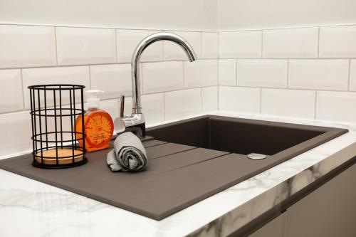 a kitchen counter with a sink and a sink at Stay Coastal in Whitley Bay