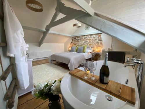 a bedroom with a bed and a bath tub with a bed at Cosy Fisherman’s Cottage: 150m to Brixham Harbour in Brixham