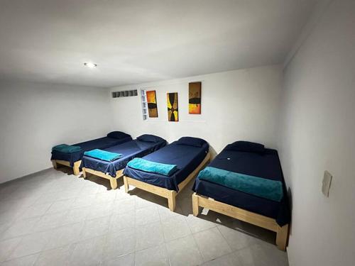 um quarto com três camas num quarto em Suite#10 Cerca de Auto. Mex-Qro. em Cuautitlán Izcalli