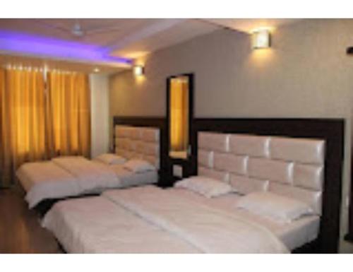 Krevet ili kreveti u jedinici u objektu Hotel Kimaya, Kurukshetra