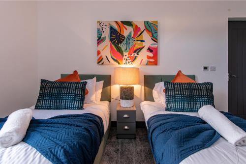 1 dormitorio con 2 camas y una lámpara en una mesa en Victoria Apartments: Contractor's Choice 3BR in Hartlepool, en Hartlepool