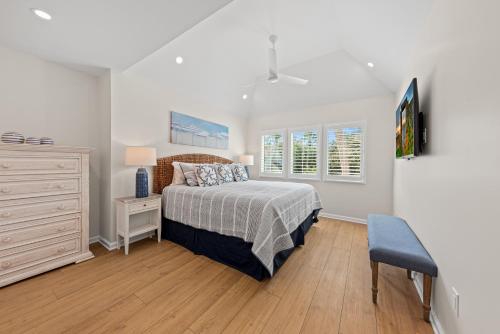 a bedroom with a bed and a dresser and window at 770 Spinnaker Beach House in Seabrook Island