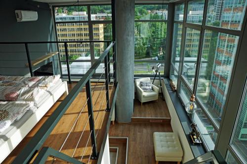 a view of a room with a bed and a balcony at View Skyscraper Bata - loft XL in Zlín