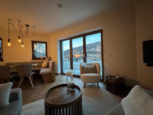 a living room with a couch and a dining room at Haus Schlatti in Altenmarkt im Pongau