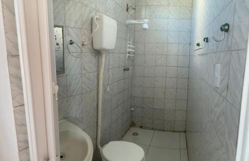 a bathroom with a toilet and a shower at Suítes Mar Azul in Aracaju