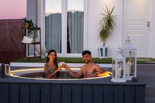 a man and a woman sitting in a bath tub at Casita tentación con jacuzzi Privado in Málaga