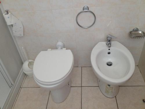 a bathroom with a toilet and a sink at Hotel Belforte in Varese