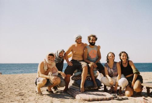 a group of people sitting on the beach at Makany Makanak Camp in Dahab