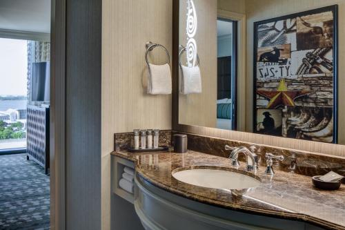 a bathroom with a sink and a mirror at Gaylord Texan Resort and Convention Center in Grapevine