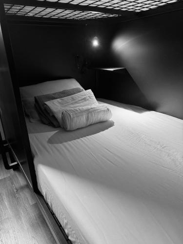 a black and white photo of a bed in a room at KAMA CENTRAL PARK in New York