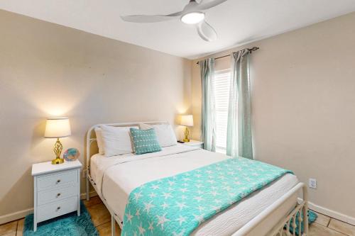 a bedroom with a bed and a window at Leeward 9303 in Padre Island