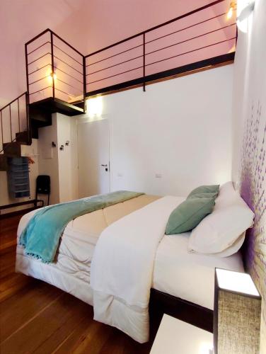a bedroom with a large white bed with a loft at Loft Centro Storico Accesso Senza Scale "Carvajal Rooms " Due Passi dal Duomo, Netflix Incluso in Orvieto