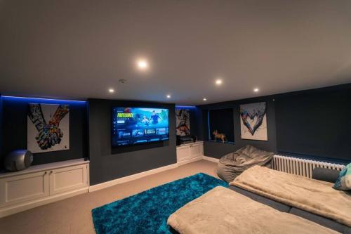 a bedroom with a bed and a flat screen tv at 3 The Steyne - Stunning 5 Storey Georgian house with cinema room in Worthing