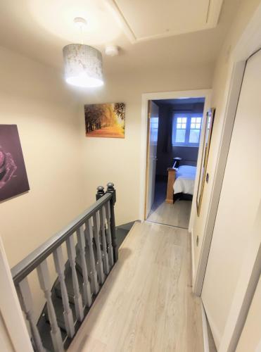 a staircase in a house with a hallway and a room at High Rigg House Bradford - Luxury Accomodation with Private Parking in Idle