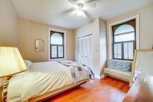 a bedroom with a bed and two windows at Unique Wheeling Condo in Historical Monastery! in Wheeling