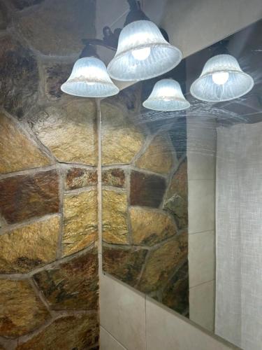 two lights hanging from the ceiling in a bathroom at Casa en el corazón de Huacalera, Jujuy in Tilcara
