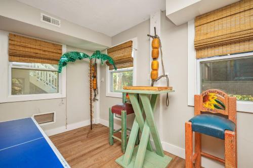 a kitchen with a table and a stool at Fairwinds by Oak Island Accommodations in Caswell Beach