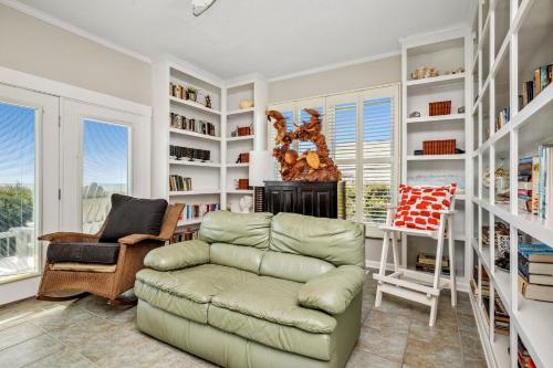 a living room with a couch and a chair at Fairwinds by Oak Island Accommodations in Caswell Beach