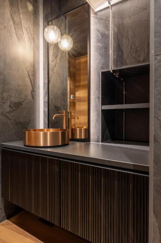 a bathroom with a sink and a mirror at Jänkä Penthouse in Levi