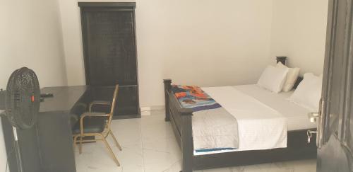 Schlafzimmer mit einem Bett, einem Schreibtisch und einem Stuhl in der Unterkunft Dakunaia 
