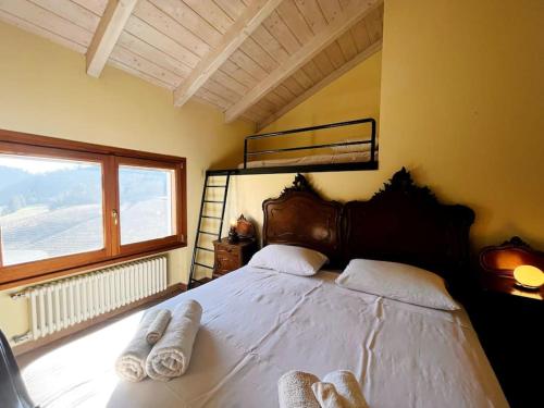 Casa Mina(Wi-fi & TV) في Serralunga di Crea: غرفة نوم بسرير كبير عليها مناشف