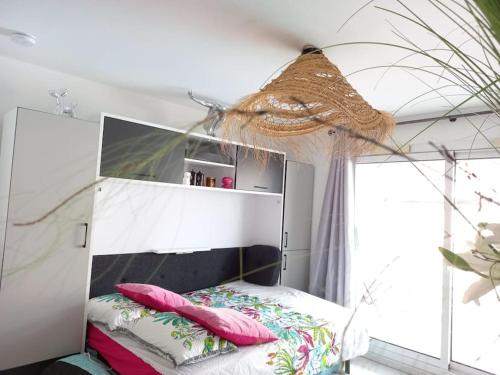 - une chambre avec un lit doté d'une tête de lit et d'oreillers dans l'établissement Port Azur Studio cabine 4 P - Pool beach Golfe Juan 5 min Cannes, à Vallauris