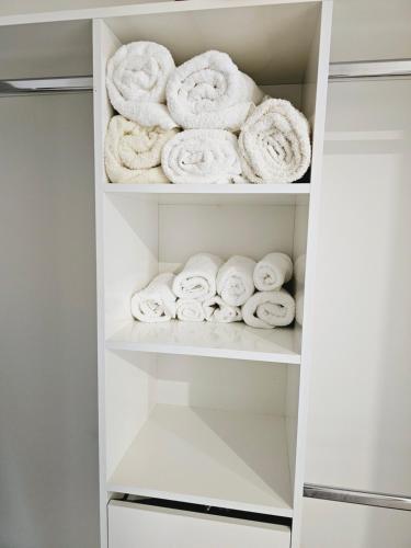 a closet filled with white towels at Hillcrest Home in Hamilton