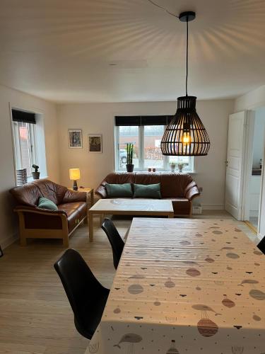 a living room with a couch and a table at Casa Home of Bricks - Downtown Holidays in Billund