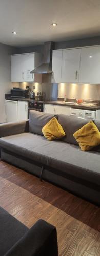 a large bed in a kitchen with two yellow pillows at Lewis Apartment in the Heart of the Northern Quarter sleeps up to 12 in Manchester